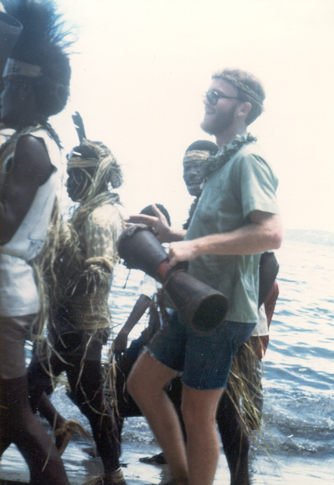 Linguist beating kundu drum